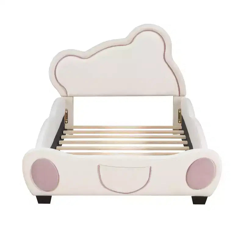 Lit plateforme tapissé de velours avec tête de lit en forme d'ours et poche de rangement au pied du lit